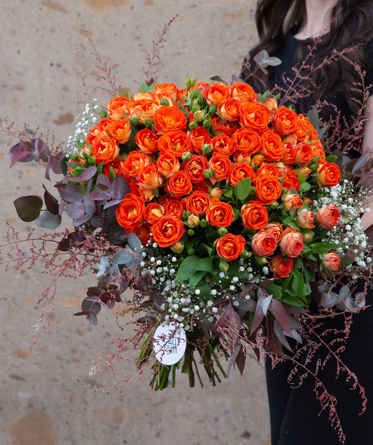 Bouquet `Logoisk` with bouquets of roses, gypsophila