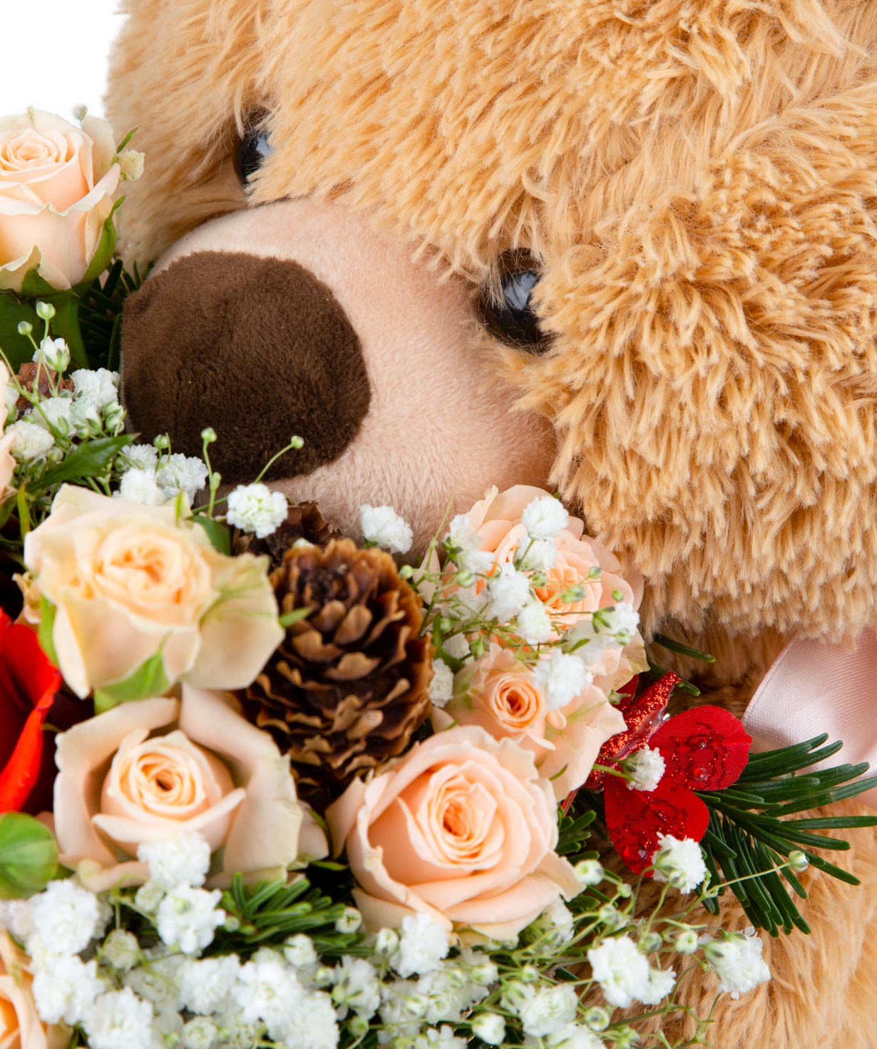Composition ''Surprise'' with a teddy bear toy, roses, gypsophila, and Xmas tree branches